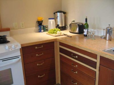 The sink counter is linoleum, bonded to a plywood core. Linoleum is a natural material (jute, stone dust, linseed oil, wood fiber, etc), particularly in comparisan to laminates. We were very happy with the result. It looks great and so far seemed very easy to work with.